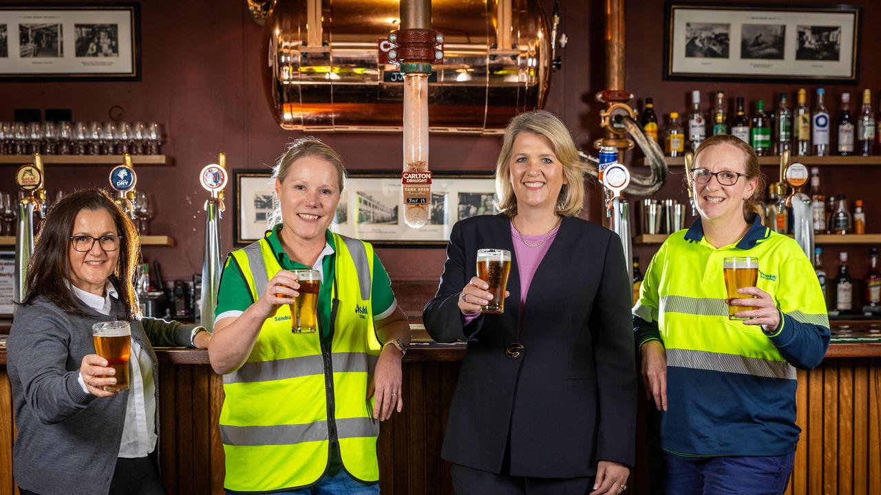 Abbotsford brewery workers toast their success, and for some buyers the aroma their job brings to the suburb is a rich, malty selling point. Picture: Jason Edwards.