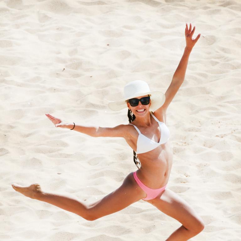 18 year old Summer Matthews Jumps for joy that sun has come out at Coolangatta Beach Photo: Scott Powick Newscorp