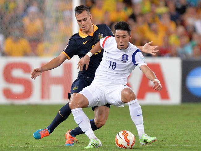 Trent Sainsbury of Australia, left, and Lee Jeonghyeop of Korea Republic.