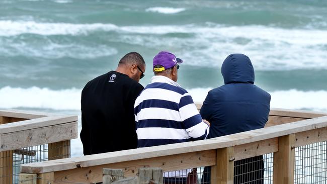 Joji Kinivuwai and family at 16th Beach at Rye where his younger brother, Jona, was swept out to sea last night. Picture: Andrew Henshaw