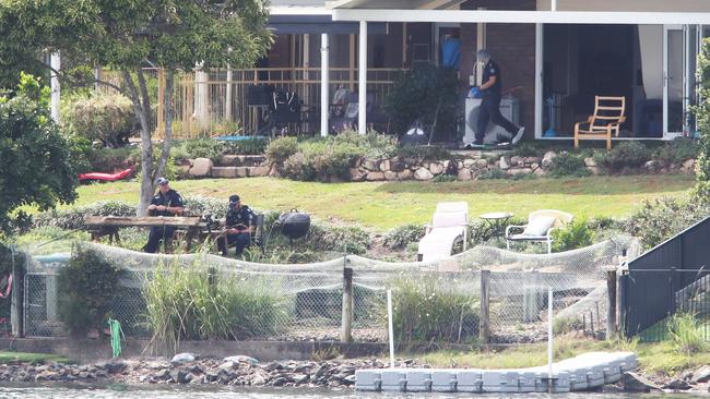 Police Forensic officers scour a property at Ironbark Street Elanora, after a woman went missing from the house. Picture Glenn Hampson