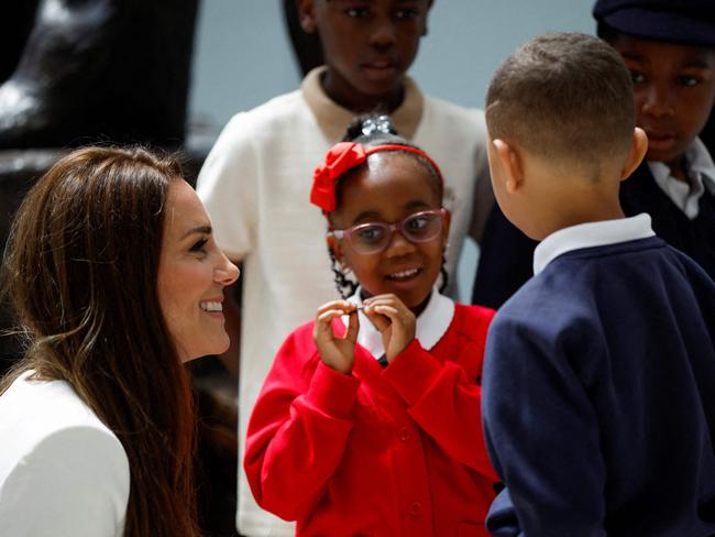 Kate chats with children at Waterloo Station. Picture: John Sibley/AFP