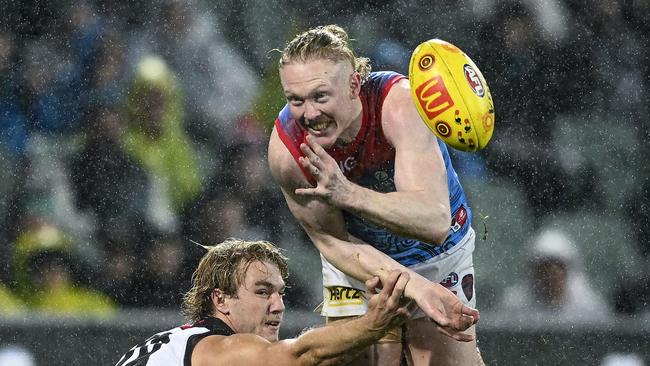 Clayton Oliver of the Demons handballs under pressure from Jason Horne-Francis of Port Adelaide. Picture: Mark Brake/Getty Images