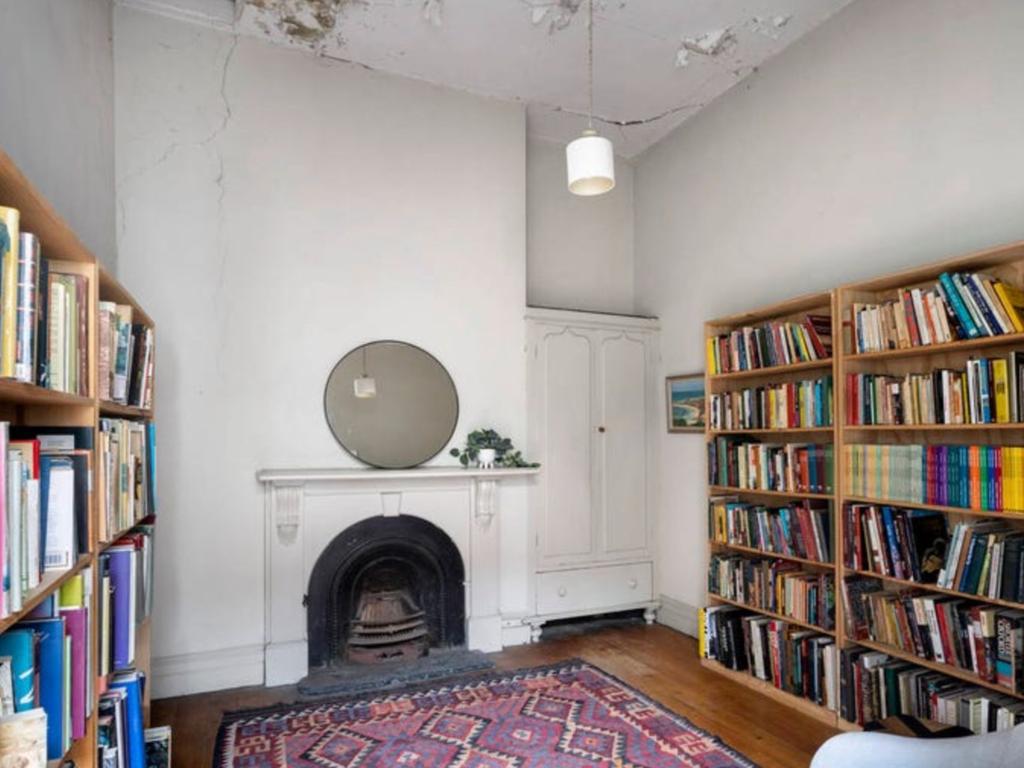 Patches of peeled off paint and cracks dominate the library's ceiling. Picture: realestate.com.au