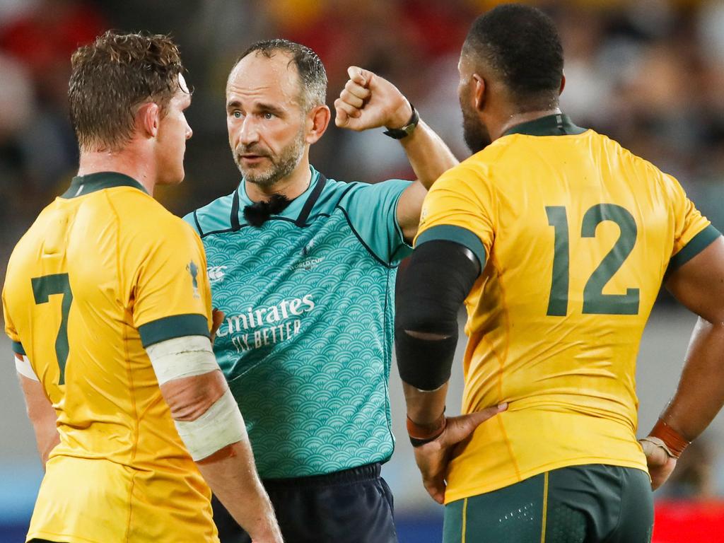 Australia's flanker Michael Hooper and centre Samu Kerevi listen to French referee Romain Poite. (Photo by Odd ANDERSEN / AFP)