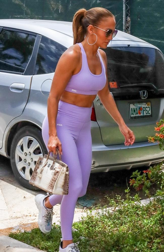 Addison Rae shows off her toned abs in a pink sports bra and