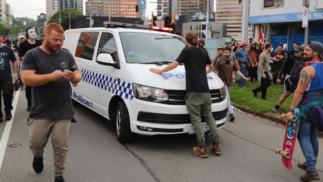 A police van is caught in the crowd. Picture: Alex Coppel