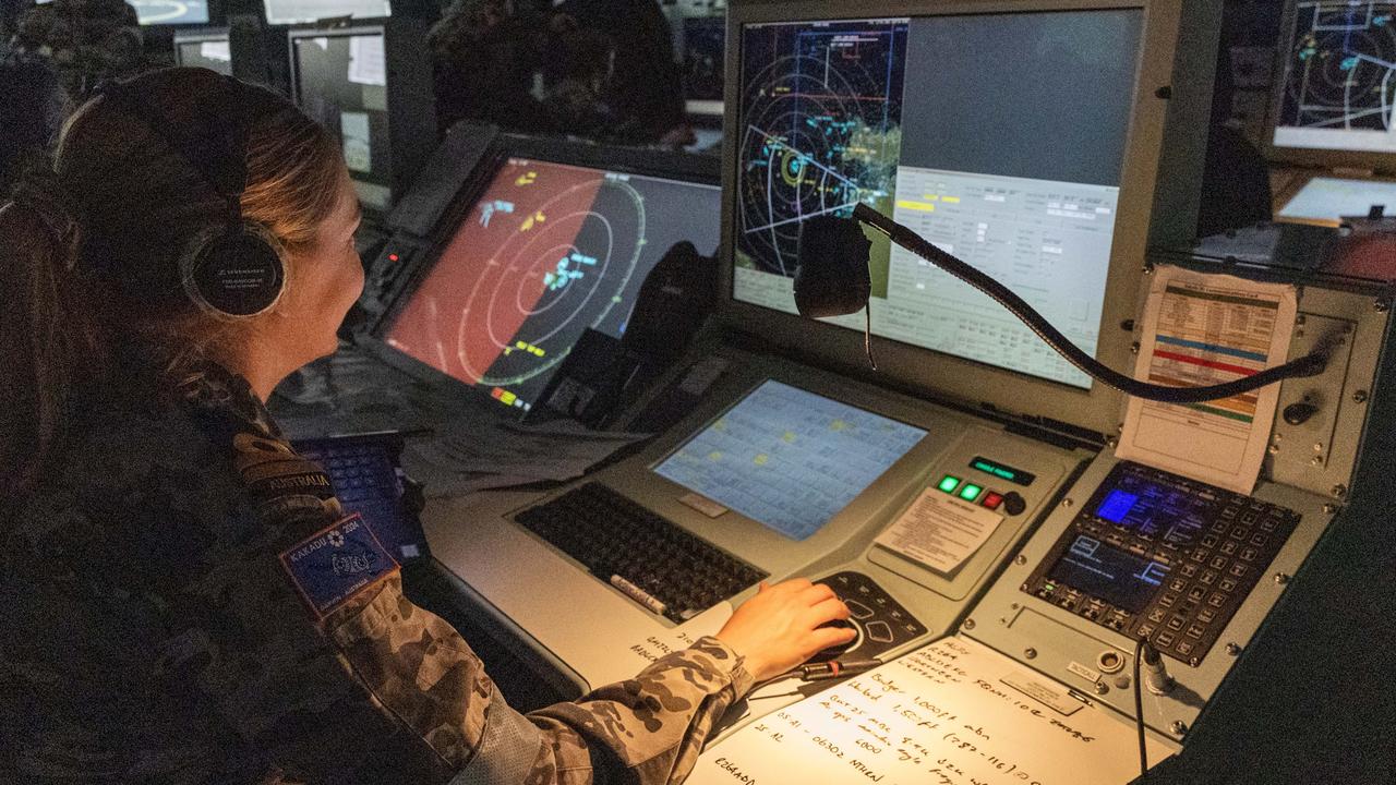 Lieutenant Amy Steele monitors air operations from the operations room on board HMAS Warramunga. Picture: Department of Defence.