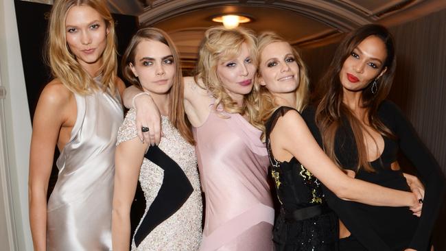 LONDON, ENGLAND - DECEMBER 01: (L to R) Karlie Kloss, Model of the Year winner Cara Delevingne, Courtney Love, Poppy Delevingne and Joan Smalls attend the British Fashion Awards at the London Coliseum on December 1, 2014 in London, England. (Photo by David M. Benett/Getty Images)