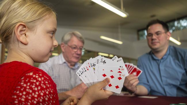 Waverley Bridge Club members Maisie, Robert Quirk and Tim Lewinski play a hand. Picture: Valeriu Campan