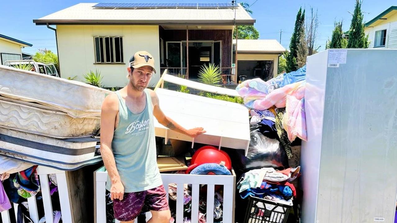 Rawdon Pierpoint was discarding all the contents of the home he shares with partner Kelly Cassotti and their three young children. The house, which recently installed a $30,000 solar system, is severely damaged, unliveable and likely a write off. Raging floodwaters reached the power box and Ergon is still yet to restore power, if ever. Picture: Supplied