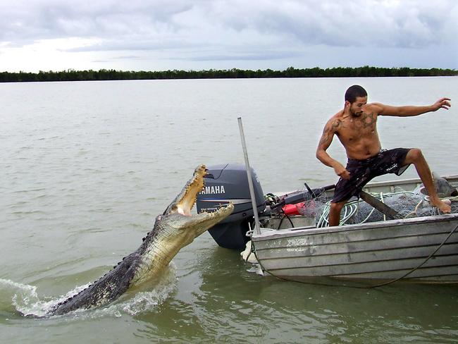 Northern Territory fisherman Novon Mashiah had been leaning over the back of his boat to pose for a photo moments before this shot was taken. The 4m saltwater crocodile then exploded out of the water, and landed on the side of the boat. Picture: Doron Aviguy