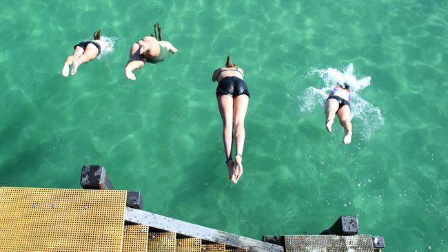 Beach goers at Henley Beach enjoying the warm weather on February 8. Picture: NCA NewsWire / Kelly Barnes