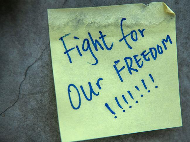 A message is written on a post-it note stuck to the wall of a walkway near the Legislative Council building in Hong Kong. Picture: Getty