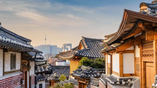 Bukchon Hanok Village and Seoul city skyline.