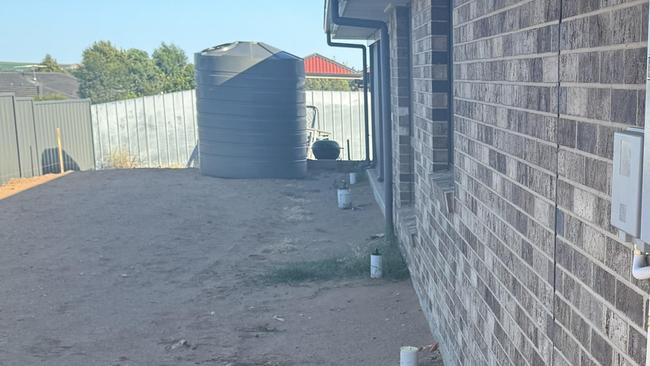 The rainwater tank was delivered, but not installed, and lacks a connection point to allow its use. Picture: Supplied