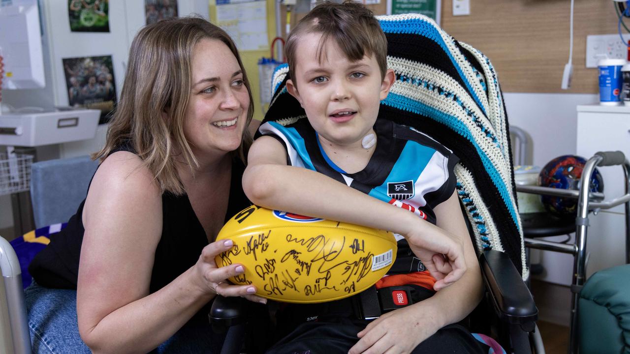 Fraser Suggate, 9, is a massive Port fan who is battling brain cancer, with his mum Simone Suggate and he received a signed jersey and football from the Port Adelaide football club and The Advertiser. Picture: Kelly Barnes