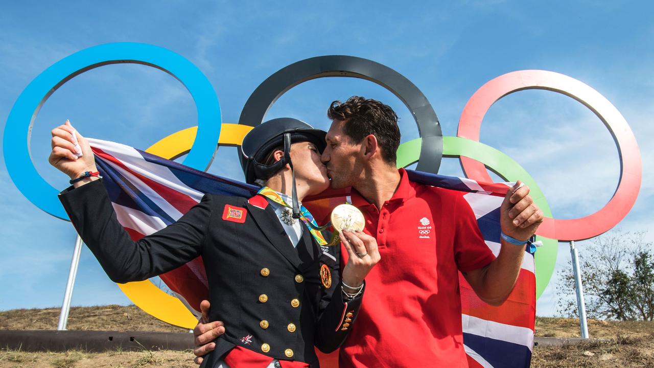 Dujardin kissing her fiance Dean Golding after winning gold at the 2016 Rio Games. (AFP PHOTO/John MACDOUGALL)