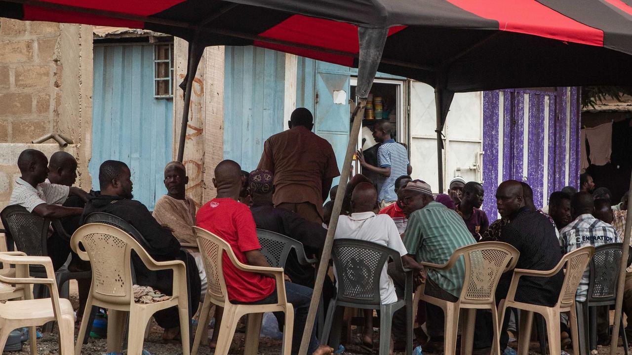 Relatives and friends of murdered Ghanian undercover reporter Ahmed Hussein Suale sit during a mourning gathering in Accra. Picture: AFP