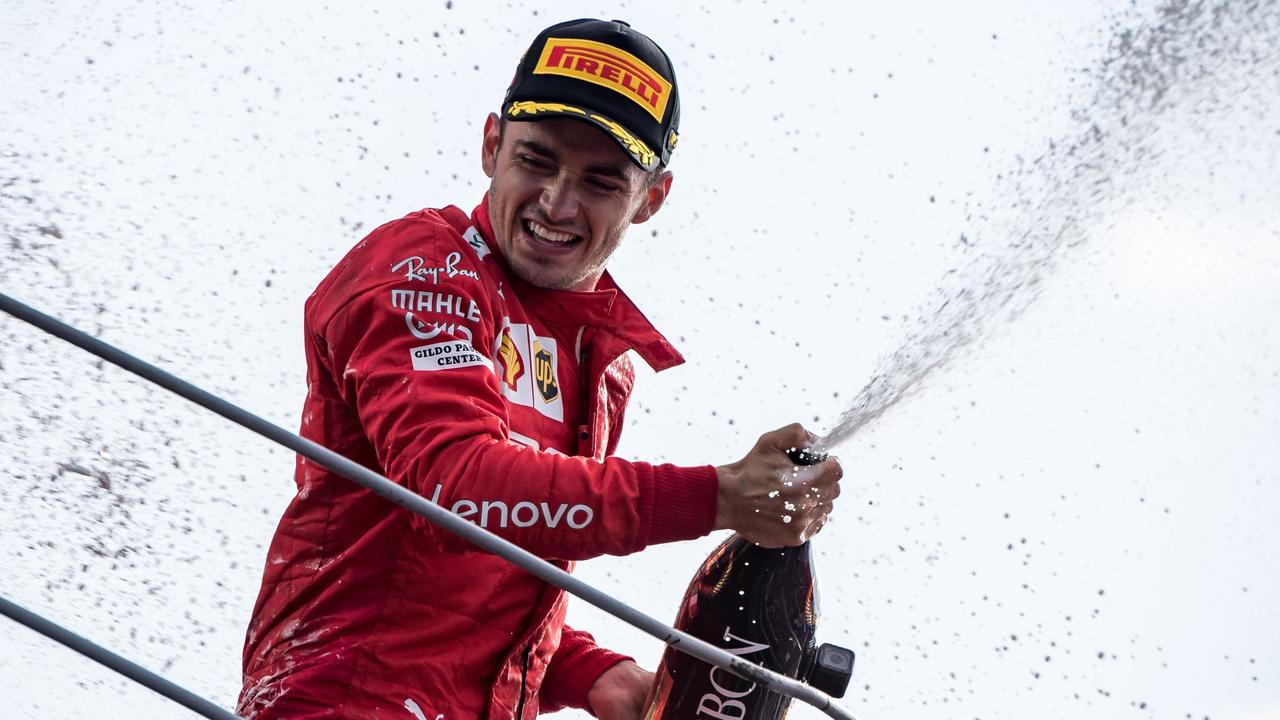Charles Leclerc celebrates with champagne on the podium in Monza.