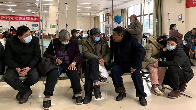 Covid-patients rest in a hallway at Fengyang People's Hospital in east China's Anhui Province. Picture: AFP