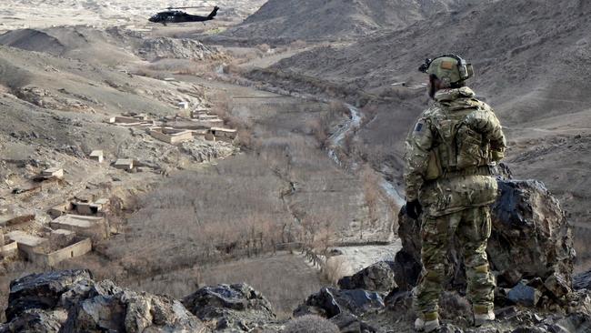 An Australian soldier looks over Chernartu, Afghanistan, the site of an alleged war crime murder as claimed by Nine, but denied by Mr Roberts-Smith.