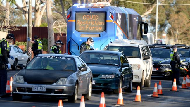 Victoria Police enforce coronavirus restrictions with a booze bus in Broadmeadows on Thursday morning. Picture: Andrew Henshaw