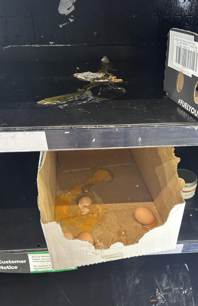 Shoppers are divided after seeing a photo of a supermarket shelf with cracked eggs smeared everywhere. Picture: Supplied