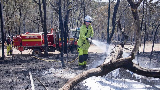 Firefighter Craig Hill from Brisbane sprays burning timbers near Watsonville. Picture: Brian Cassey