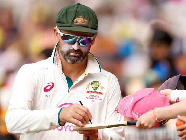 SYDNEY, AUSTRALIA - JANUARY 03: Nathan Lyon of Australia signs autographs for fans during day one of the Fifth Men's Test Match in the series between Australia and India at Sydney Cricket Ground on January 03, 2025 in Sydney, Australia. (Photo by Darrian Traynor/Getty Images)