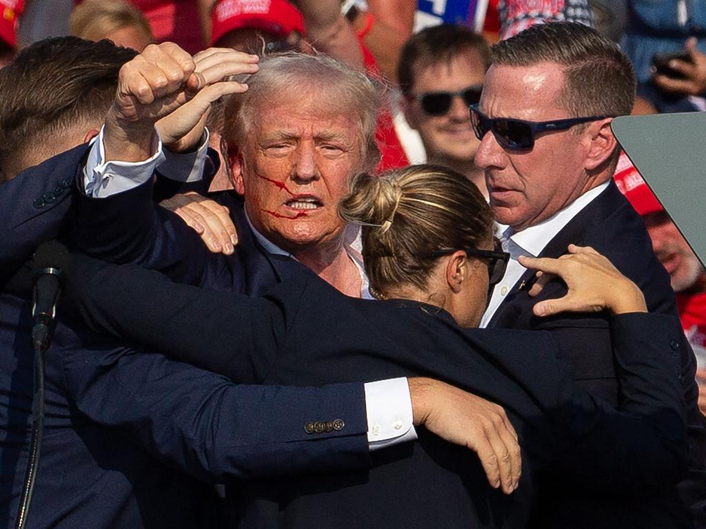 Donald Trump shuffled off stage after being shot in the ear. Picture: AFP