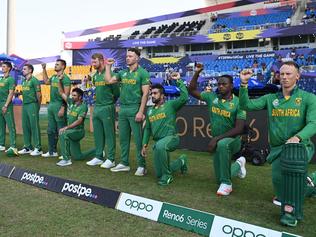 ABU DHABI, UNITED ARAB EMIRATES - OCTOBER 23: Players of South Africa take the knee ahead of the ICC Men's T20 World Cup match between Australia and SA at Sheikh Zayed stadium on October 23, 2021 in Abu Dhabi, United Arab Emirates. (Photo by Gareth Copley-ICC/ICC via Getty Images)