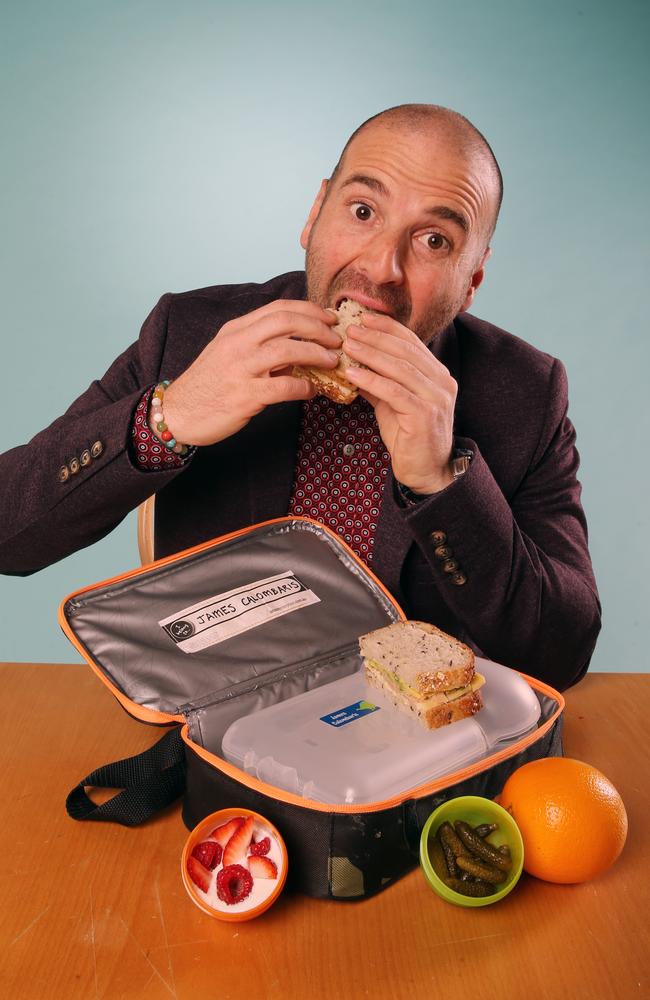 Snack attack ... George Calombaris eats his way through his son James’ lunch box. Picture: Alex Coppel.