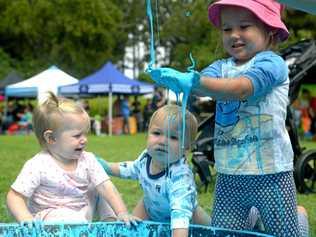 Elizabeth Ladewig, Clay and Ivy Payne get messy at the Botanic Gardens. Picture: Jann Houley