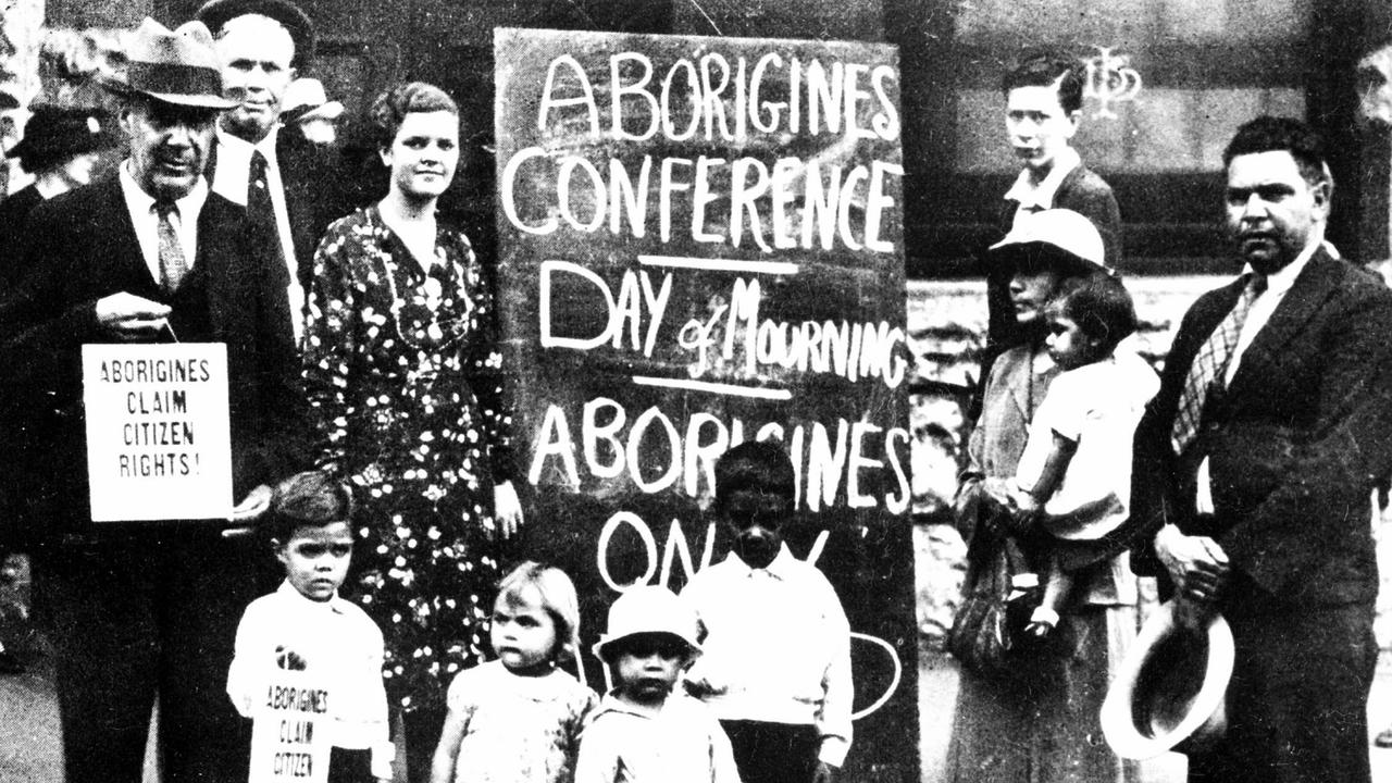 Aboriginal activist John Patten (r) with (l-r) William Ferguson, Jack Kinchela, Helen Grosvenor and Selina Patten. A large blackboard displayed outside the hall proclaims, “Day of Mourning” on January 26, 1938.