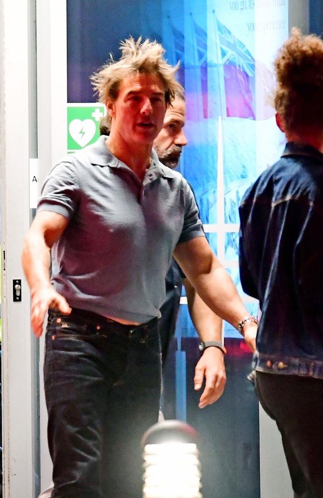 A dishevelled looking Tom Cruise shows us the perils of getting your photograph taken immediately after you’ve exited a helicopter. The Mission Impossible star was seen arriving at a heliport in London with friends. Picture: Backgrid