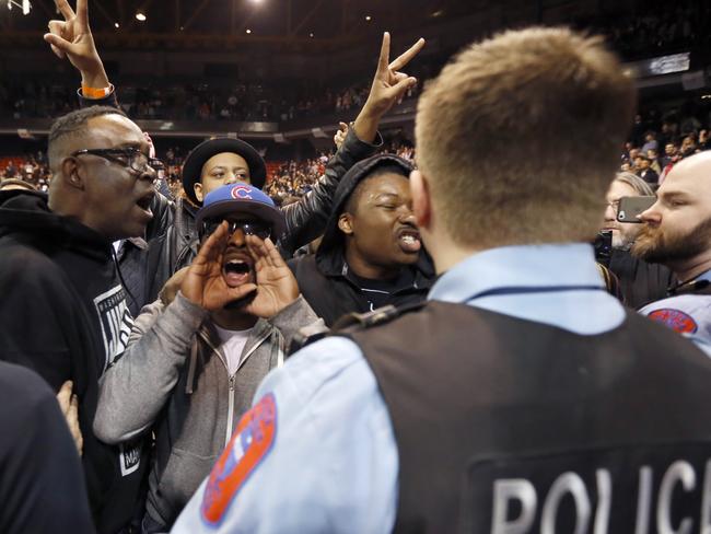 Protesters shout at Trump supporters after the Chicago rally is called off.