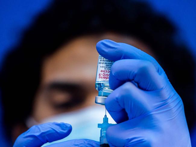 (FILES) In this file photo taken on February 16, 2021 medical worker Robert Gilbertson loads a syringe with the Moderna Covid-19 vaccine to be administered by nurses at a vaccination site at Kedren Community Health Center, in South Central Los Angeles, California. - US pharmaceutical firm Moderna said on April 29, 2021 it expects to increase global production of its Covid-19 vaccine to up to three billion doses in 2022. The company said in a statement that it would make new funding commitments to increase supply at its manufacturing facilities. (Photo by Apu GOMES / AFP)