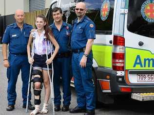 ON THE MEND: Accident survivor Colleen Tabone of Lowood thanks ambulance paramedics (from left), Peter Brown, Alex Henderson and Paul Beswick. INSET: Ms Tabone’s car shortly after the crash. Picture: David Nielsen