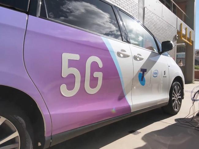 A Telstra technician works on installing 5G.