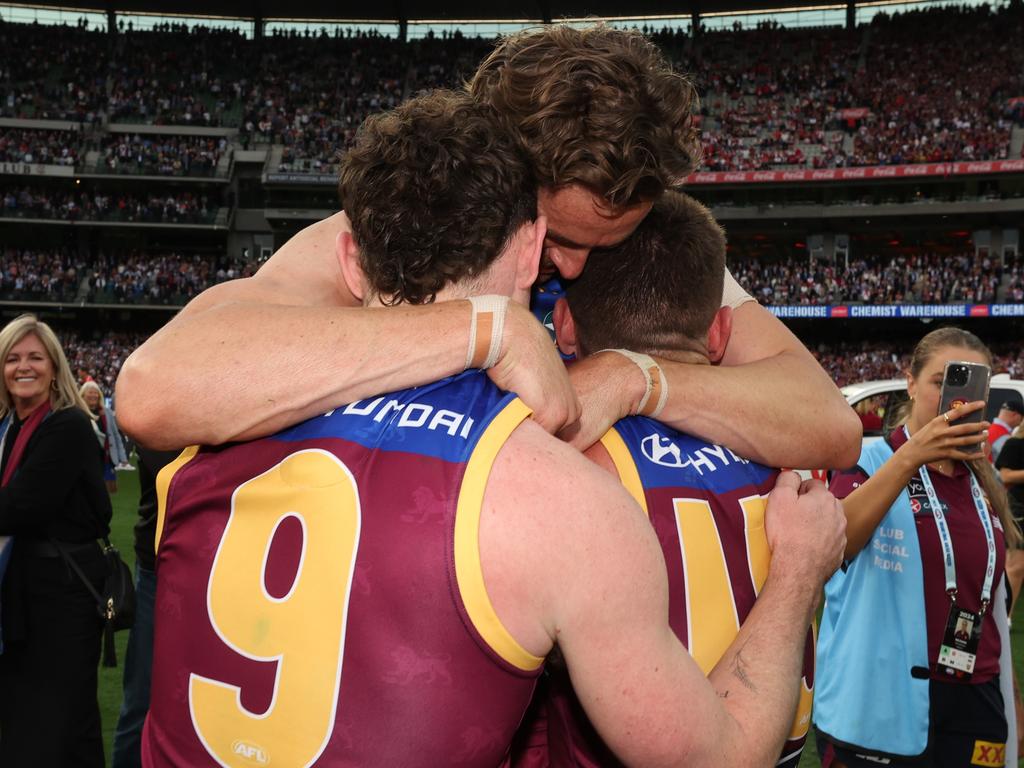 Lachie Neale, Joe Daniher and Dayne Zorko embrace after defeating the Sydney Swans at the MCG. Picture Lachie Millard