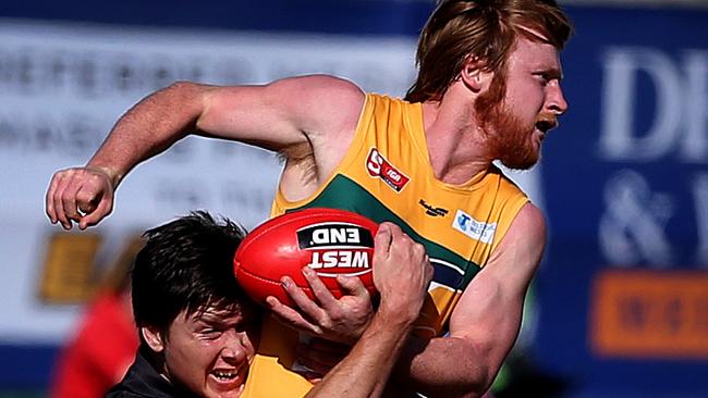 The Eagles’ Angus Poole gets a handball away under pressure against Glenelg. Picture: Dean Martin