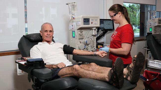 Woree man Len Bennett makes his 700th donation of blood and plasma for the Australian Red Cross Lifeblood service with the help of registered nurse Mayer Cook-Tonkin at the Cairns North Community Health centre on Monday. Picture: Brendan Radke