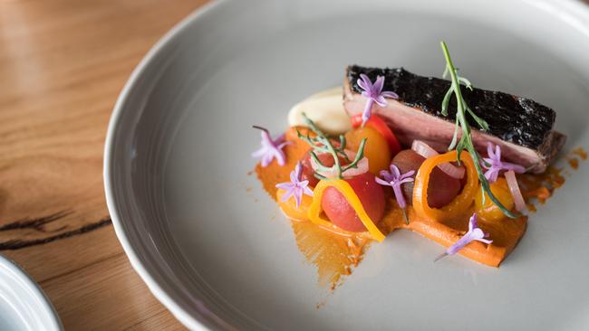 Underbar’s Ballarat Lamb rump with black and white garlic, romesco, tomatoes Picture: Jo O’Kelly