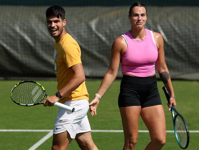 Carlos Alcaraz practicing with Aryna Sabalenka at the All England Lawn Tennis and Croquet Club. Picture: Clive Brunskill/Getty Images