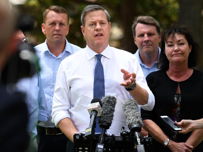 Queensland Leader of the Opposition Tim Nicholls (centre) is flanked by (at rear L to R) the Member for Indooroopilly, Scott Emerson, Member for Moggill, Dr Christian Rowan and the Member for Mt Ommaney, Tarnya Smith, as he speaks during a press conference at Mt Coot-tha in Brisbane, Monday, November 13, 2017. Mr Nicholls is on the campaign trail ahead of the November 25 state election. (AAP Image/Dan Peled) NO ARCHIVING