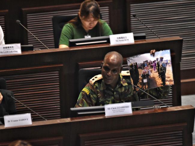 Ranger Chris Leadismo, the head of wildlife security at NGO Save the Elephants in northern Kenya holds up a photo taken during the funeral for his closest friend, who was shot dead while protecting elephants, as he speaks during a public hearing at the Legislative Council (Legco) on a government proposal to ban the sale of ivory in Hong Kong last week. Picture: Anthony Wallace