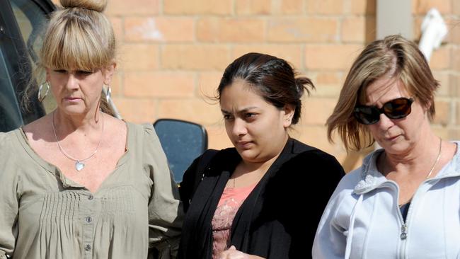 Sofina Nikat (centre) is led away by two social workers. Picture: Andrew Henshaw