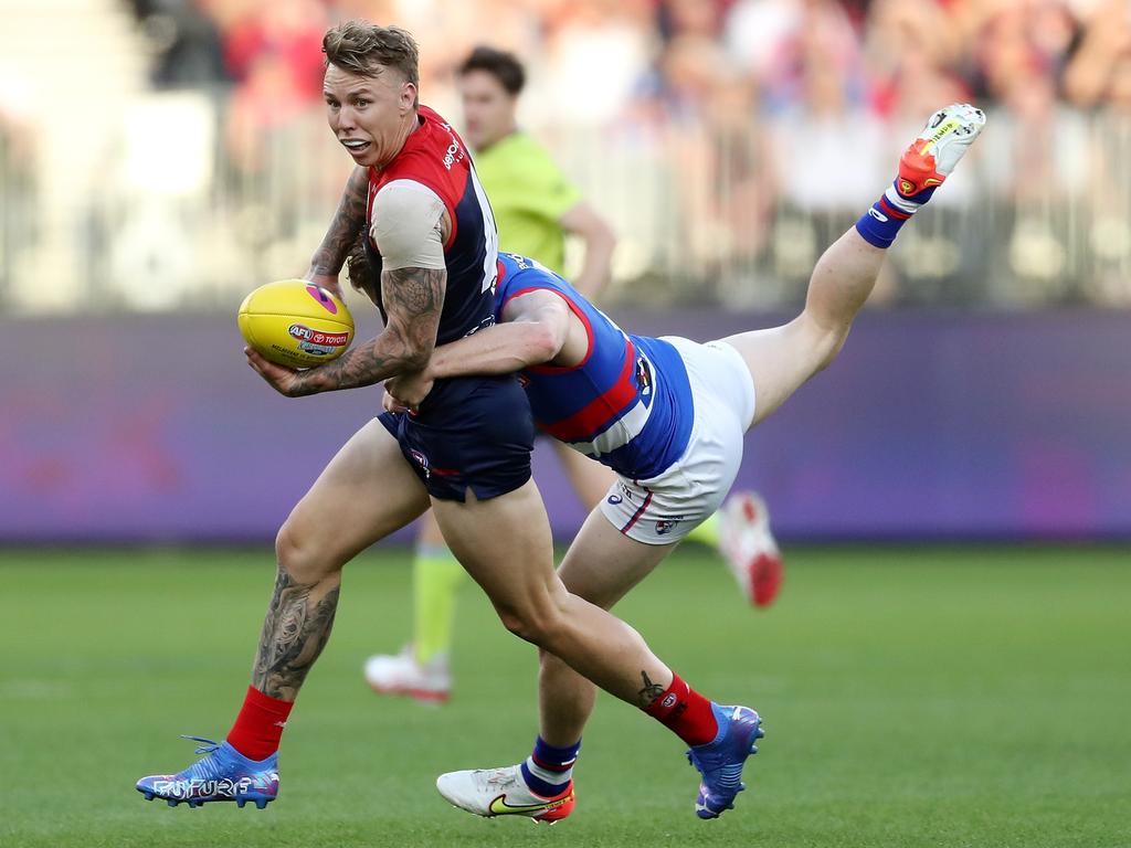 James Harmes handpasses the ball while under pressure from Lachie Hunter. Picture: Will Russell/AFL Photos via Getty Images