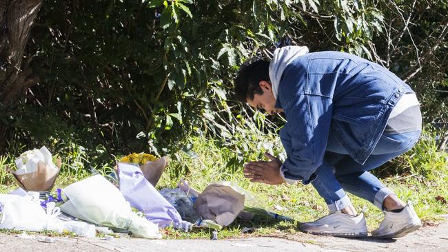 A young man leaves a tribute at the house today. Picture: Jenny Evans